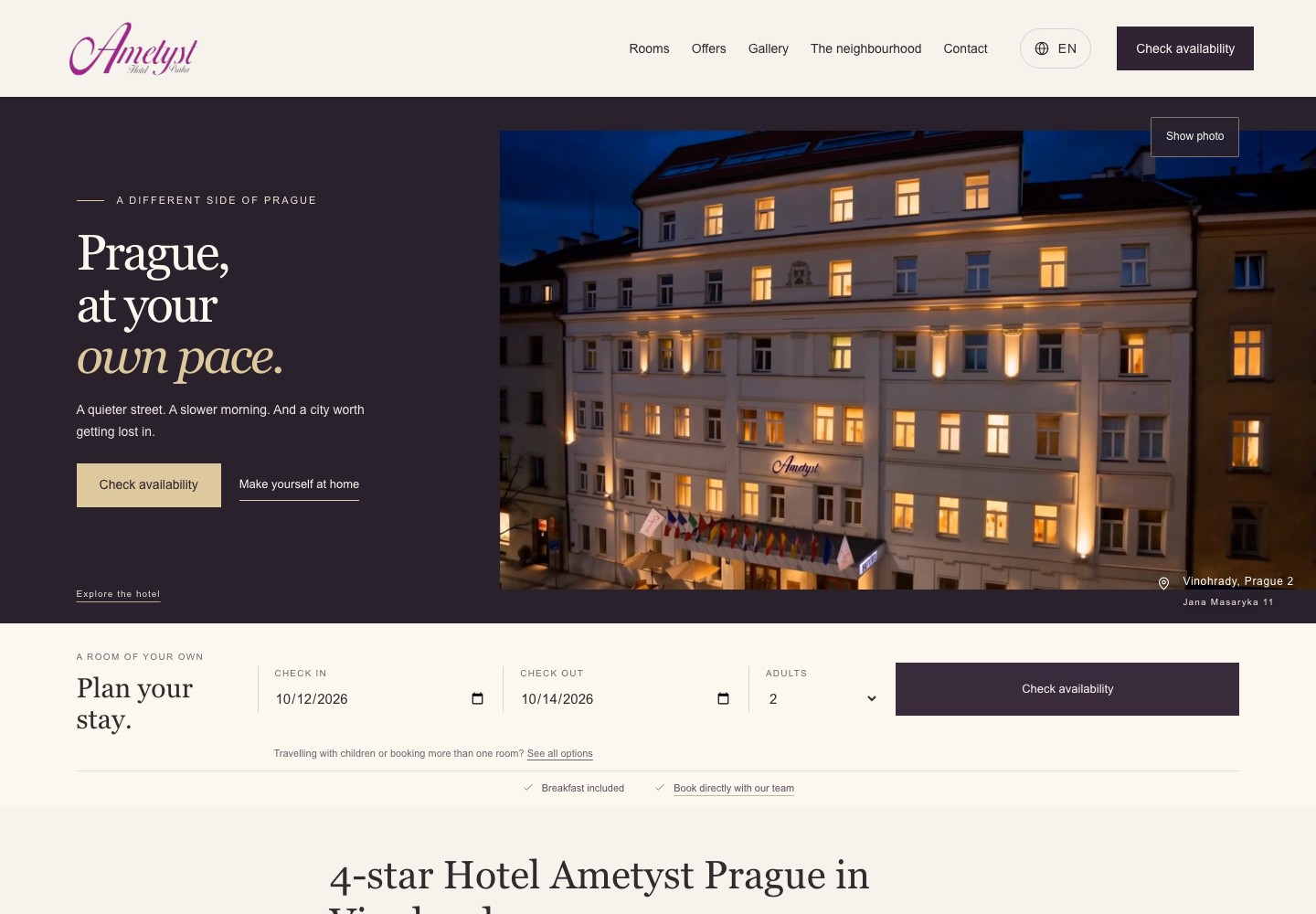 Hotel Ametyst Prague website header showing the illuminated hotel exterior